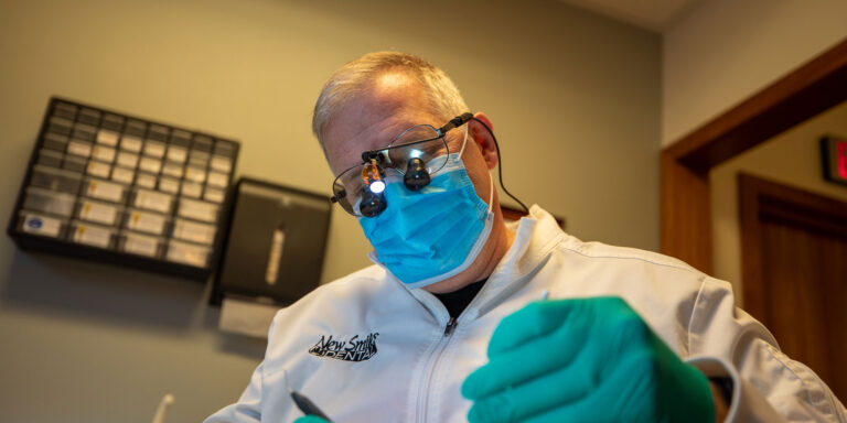 Doctor in middle of dental procedure with patient