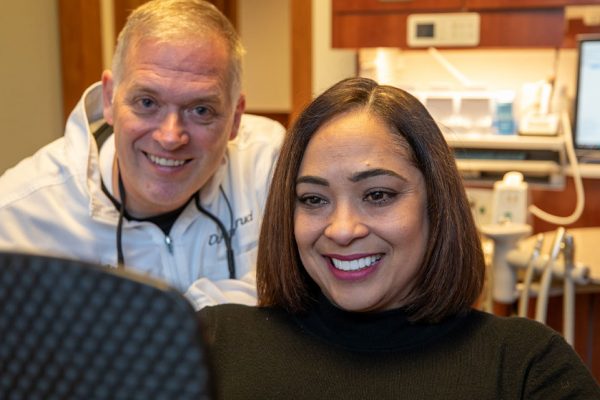 Patient and doctor smiling after their dental procedure